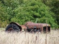 Old tractor in very long dry grass