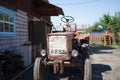 An old tractor in a village courtyard. Close-up