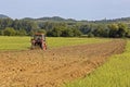 Old tractor working on the field Royalty Free Stock Photo