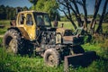 Old tractor working in the field in a rural area Royalty Free Stock Photo