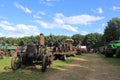 Old tractors and machines at a field at a farm event in summer