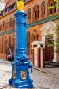 Old traditional blue water pump with gryphon head and crest from Stettin city emblem