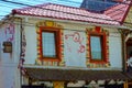 Old traditional building facade eroded by time and vandalised with graffitty at Vama Veche, Romania, July 2020