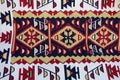 Old traditional carpet with a geometric pattern white, dark red and orange colors in arabic style on bazaar in Skopje, Republic of Royalty Free Stock Photo