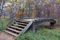 Old traditional classic wooden bridge through the river