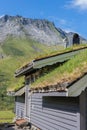 Old traditional farm house with grass on the roof in the middle of valley