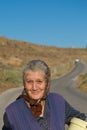 Old traditional greek woman walking with a sweet smile in Greece