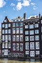 Old traditional leaning houses along the canal in Amsterdam, Netherlands