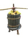 Old traditional manual wine press utensil with grape bunch isolated over white