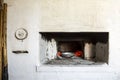 Old Russian village stove. Nearby are the tools tongs, shovel to get dishes from the hot oven with coals Royalty Free Stock Photo