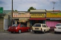 Old traditional shop houses at a small town in Malaysia with cars parked in front