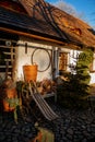 Old traditional sledge in front of old house, Christmas tree, wicker baskets on the bench, wooden roof in winter, Hotel U Raka,