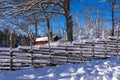 Old traditional Swedish wooden fence in winter sunny day. Vintage style fence in snow. Royalty Free Stock Photo