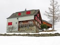 Old traditional swiss rural architecture and alpine livestock farms in the winter ambience of the region over the Lake Walen