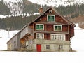 Old traditional swiss rural architecture and alpine livestock farms in the winter ambience of the region over the Lake Walen