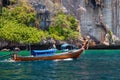 Old traditional Thai motorboat made of wood for fishing and tourists on excursions in the Andaman Sea near Phi Phi Leh island in Royalty Free Stock Photo