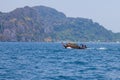 Old traditional Thai motorboat made of wood for fishing and transporting tourists on excursions in the Andaman Sea in clear Royalty Free Stock Photo