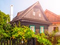 Old traditional timbered cottage with romantic and idyllic lush green flower garden with wooden fence on sunny summer Royalty Free Stock Photo