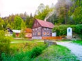 Old traditional timbered cottage with romantic with stone bridge at evening time. Czech rural architecture Royalty Free Stock Photo