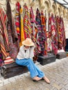 Old traditional Turkish carpet shop in cave house Cappadocia, Turkey Kapadokya. Young woman on vacation in Turkey Royalty Free Stock Photo