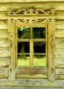 Old traditional village log house window with carved frame, Russia Royalty Free Stock Photo
