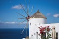 Old traditional whitewashed greek windmill on Santorini island in Oia town with stairs in street. Greece Royalty Free Stock Photo