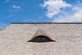 Old traditional wood planks tiles roof with eye like window Royalty Free Stock Photo