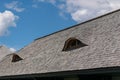 Old traditional wood planks tiles roof with eye like windows Royalty Free Stock Photo