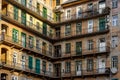 old traditional yellow residential building in Budapest with gang and green doors