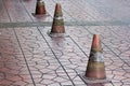 Old traffic cones placed on the sidewalk. Royalty Free Stock Photo