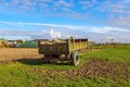 Old trailer car with construction material on agricultural plot Royalty Free Stock Photo