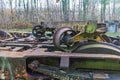 Old train bogie with two pairs of wheels thrown away and stacked on huge rusty steel structure Royalty Free Stock Photo