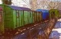 Old train with colorful, wooden, wagons with peeling paint in gre Royalty Free Stock Photo