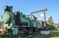 Old train locomotive green color on network of narrow-gauge railway in Carpathian village Kolochava, Ukraine