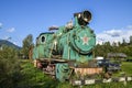 Old train locomotive green color on network of narrow-gauge railway in Carpathian village Kolochava, Ukraine