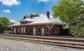 An old train station alongside the railroad tracks. Royalty Free Stock Photo