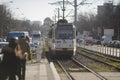 Old tram arriving in a station on a Bucharest boulevard on a sunny winter day Royalty Free Stock Photo