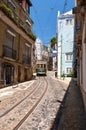 Old tram number 28 on the narrow street of Alfama. Lisbon. Portugal