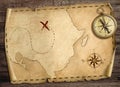 Old treasure pirates` map with compass on wood table. 3d illustration. Royalty Free Stock Photo