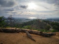 An old tree fallen on the hill top with sunny sky above. Royalty Free Stock Photo