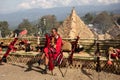 An old tribal Naga warrior dressed in traditional attire siting with traditional naga weapons Royalty Free Stock Photo