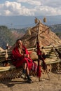 An old tribal Naga warrior dressed in traditional attire siting with traditional naga weapons Royalty Free Stock Photo