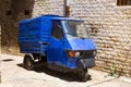 Old tricycle ape standing at the empty street of old italian town Royalty Free Stock Photo