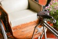 Old tricycle with beige leather cushion