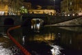 Old trolley car on Darsena embankment at night life time , Milan
