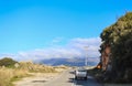 Old truck approaching extreme curve on two lane road in the mountains with fog topped mountian range in the distance