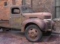 Old truck in brick alley.