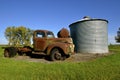 Old truck left by grain bin