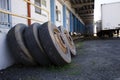 Old truck wheels stand near the warehouse wall with cargo gateway Royalty Free Stock Photo