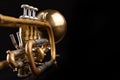 Old trumpet on a dark wooden table. Wind instrument in the old style Royalty Free Stock Photo